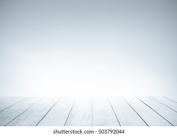 White Old Wood Floor With Blurred Blue Gray Tone Background. Wooden Planks Stage Texture And Blur Flare Sunlight. Abstract Medical Backdrop. Focus To Table Top In The Foreground.