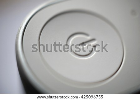 White ON and OFF circle button used to turn on and turn off the electric equipment in the modern design made of silver aluminum and white plastic 