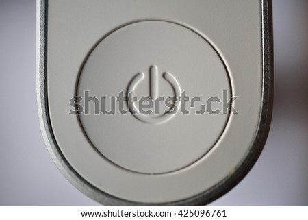 White ON and OFF circle button used to turn on and turn off the electric equipment in the modern design made of silver aluminum and white plastic 