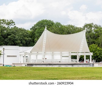 A White Open Air Stage In A Green Park