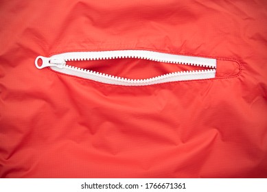 White Open Zip Or Zipper On A Red Jacket 