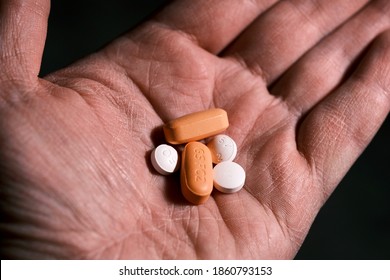 White And Orange Antiretroviral Therapy Pills For Treatment Of HIV In Hand. Dolutegravir, Abacavir, Lamivudine. World AIDS Day Concept. Healthcare And Medicine. Tablets And Medication. Horizontal Pic.