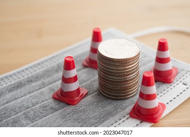 White Orange Under Construction Cone Around Stacked Coins On Mask. Global Economy Crisis Due To COVID-19, Fix Repair Or Reset Investment Plan, Money Saving Management. Business And Financial Concept.