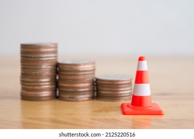 White Orange Under Construction Cone And Stacked Coins As Graph Chart Down With Copy Space. Revise Or Reset Investment, Money Saving Management Plan Or Economy Crisis. Business And Financial Concept.