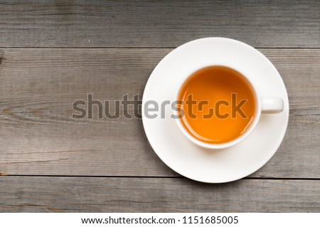 white organic green tea cup on rustic table