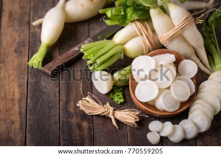 White organic radishes on the wooden table