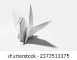 White origami paper bird on white background