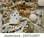 White ornaments on a flocked Christmas tree