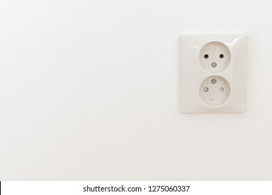 A White Outlet, Socket, Plug On A White Wall In The Living Room, Bedroom, Inside The House, Interior