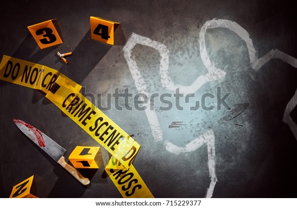 White outline of victim and bloody\
knife marked with number evidence markers at crime\
scene