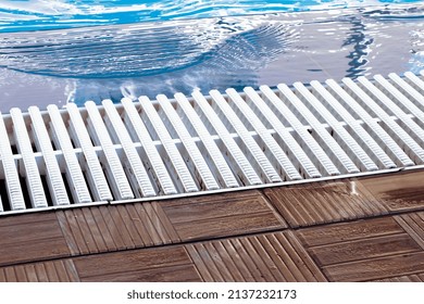 White Overflow Grate Installed Near The Pool 