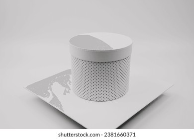 A white ovoid shaped gift box on a white background