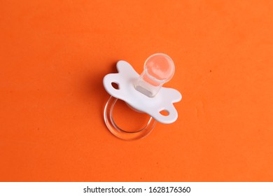 white pacifier in color background