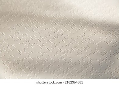 White page with a pattern of dots. Braille sheet.