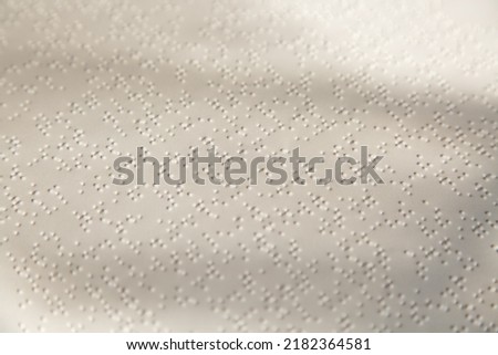 White page with a pattern of dots. Braille sheet.