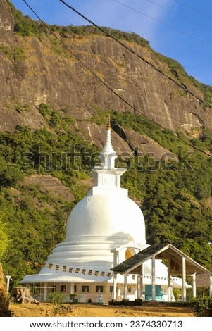 White pagoda at the foosteps of the Adam's Peak, tallest mountain in Sri Lanka. Background image with copy space for text