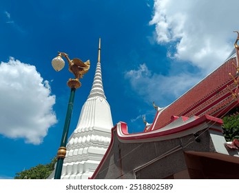 White pagoda and golden swan-shaped lamp post. - Powered by Shutterstock