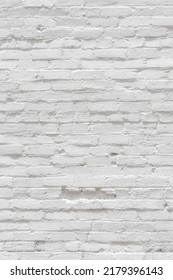 White Painted Brick Wall With Dent For Texture Or Background. Aged Bricks