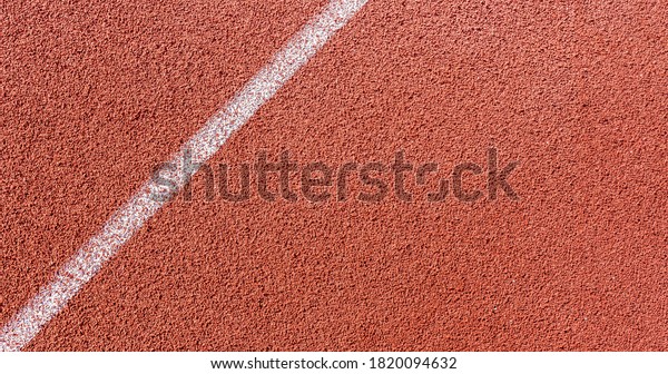 White painted line on tartan ground track in a\
athleticism and sports field.\
