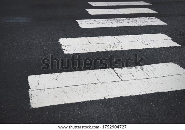 White\
painted road zebra surface crossing on an\
angle.