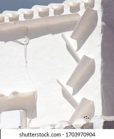 White painted wall with gutter in the small village of Binibeca. Menorca. Balearic Islands. Spain