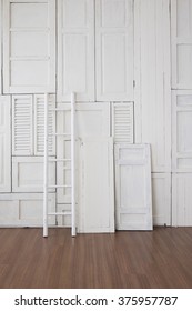 White Painted Window Hinge On Wall With White Ladder On Wooden Floor 