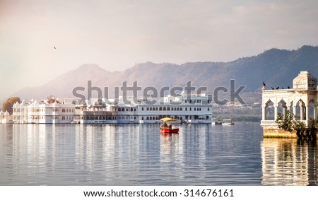 White palace and boat on Lake Pichola in Udaipur, Rajasthan, India