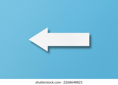 white paper arrow isolated on light blue paper background - Powered by Shutterstock