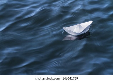 White Paper Boat On Blue Water