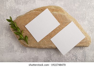 White Paper Business Card, Mockup With Natural Stone And Boxwood Branch On Gray Concrete Background. Blank, Flat Lay, Top View, Still Life, Canvas, Copy Space.