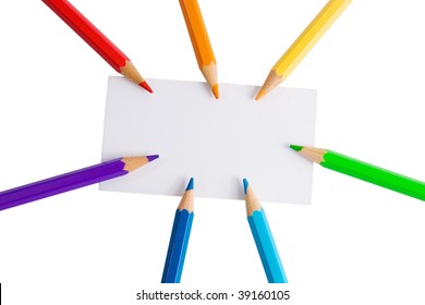 White paper card and seven color pencils of rainbow colors (isolated on white)