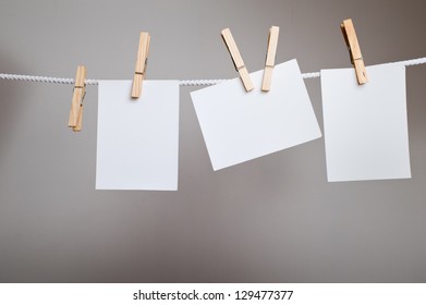 White paper cards on clothes-pegs - Shutterstock ID 129477377