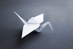 White paper crane origami isolated on a grey background, an Animal ...