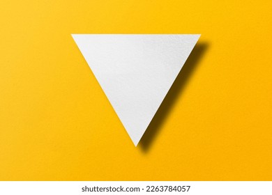White paper cut into triangle shape, play button set on yellow paper background. - Shutterstock ID 2263784057