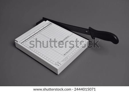 White Paper Cutter isolated on grey background