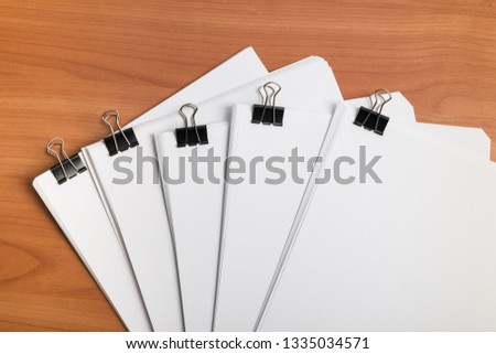 White paper document template with metal clips binder on work table top view