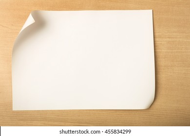 White paper with fold corner on wood background, Blank paper