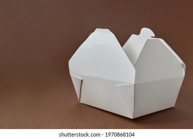 White paper food container on brown background