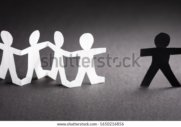 White paper human chain\
doll disconnect the black one, partnership concept or metapor to\
anti racism