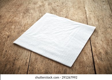 white paper napkin on old wooden table - Shutterstock ID 291267992
