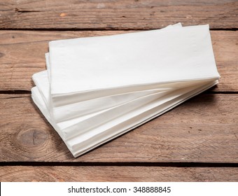 White Paper Napkins on old wooden table.