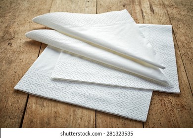 white paper napkins on wooden table