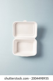 White Paper Plastic-free Food Container Isolated On Blue Background, Vertical Top View. Single-use Dinnerware Non-plastic Alternatives Concept. Minimalistic Eco-friendly Pack Takeaway