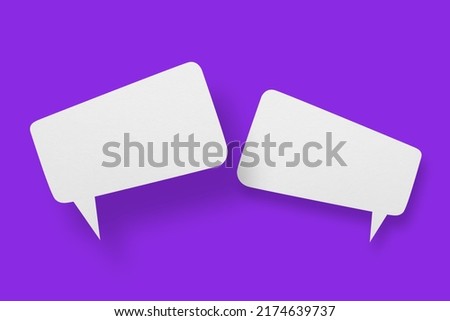 White paper in the shape of speech bubbles against a purple background. Communication bubbles.Design