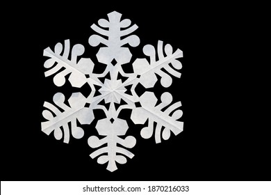 White Paper Snowflake On Black Background, Copy Space. Handmade New Year Decoration