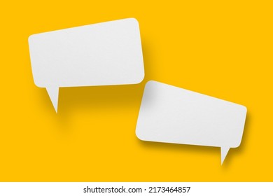 White paper in speech bubble shape set against yellow background.Communication bubbles.