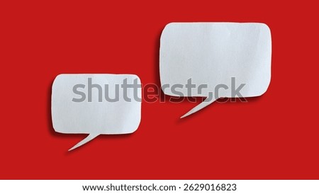 White paper speech bubble shape for design in your work business concept. Minimalist speech bubbles on red background.
