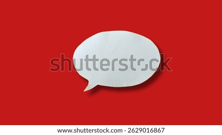 White paper speech bubble shape for design in your work business concept. Minimalist speech bubbles on red background.