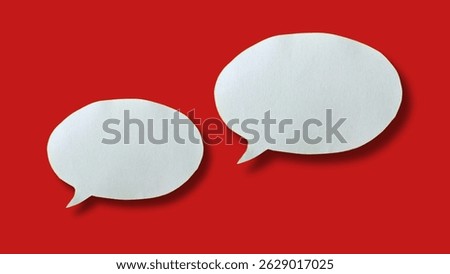 White paper speech bubble shape for design in your work business concept. Minimalist speech bubbles on red background.
