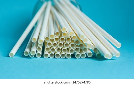 White Paper Straws Against Blue Background 